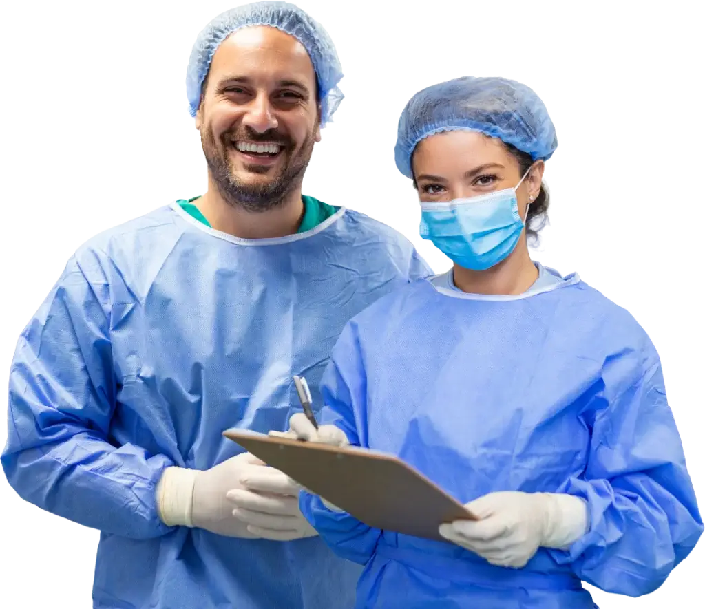 Two medical professionals in blue scrubs and masks; one smiling, the other holding a clipboard and pen.